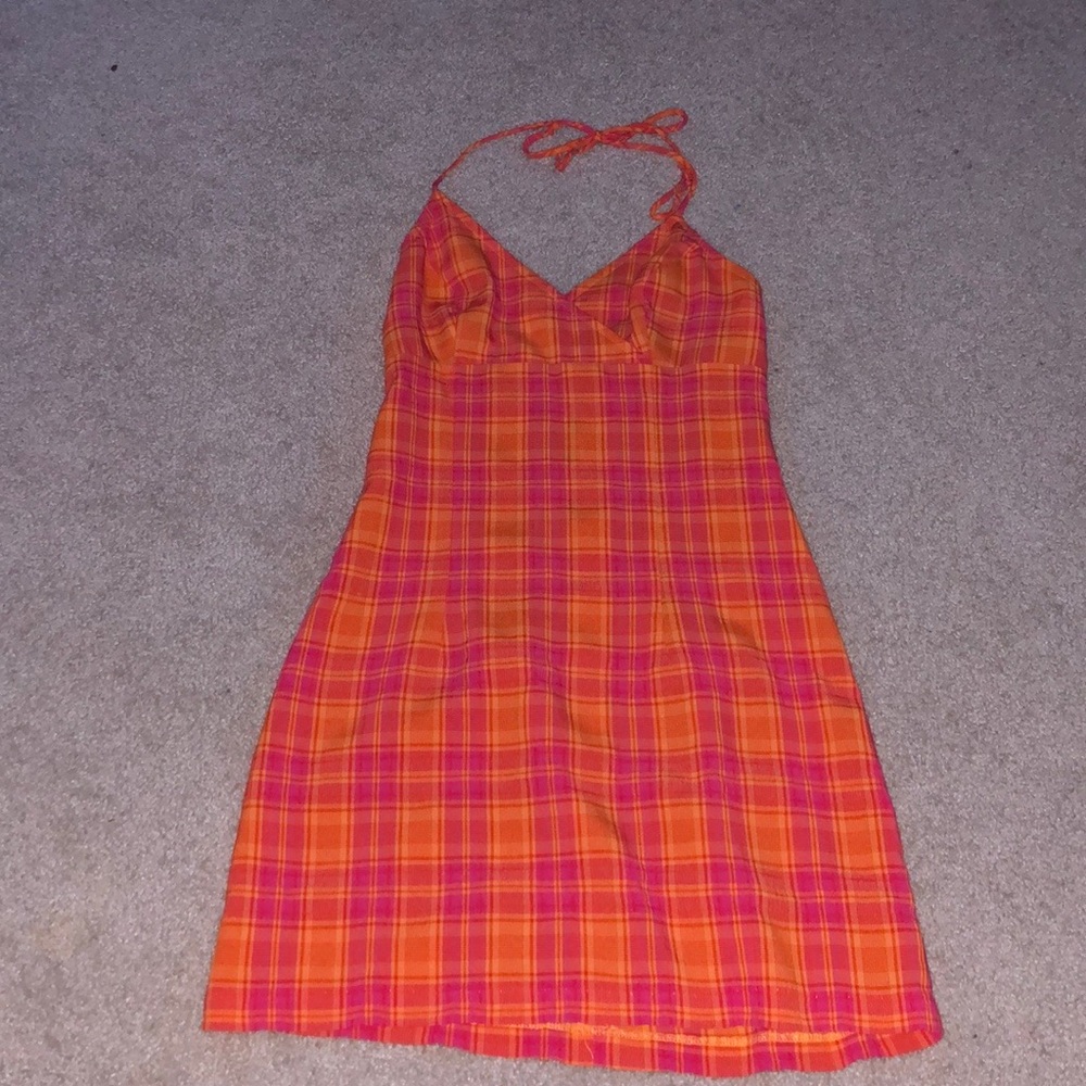 this is a mini orange, red, and pink plaid dress that ties around the neck